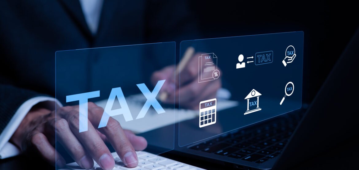 Businessman using a computer to complete Individual income tax return form online for tax payment. Vat and property tax of business. tax calculation, Corporate and individual tax payment concept. Businessman using a computer to complete Individual income tax return form online for tax payment. Vat and property tax of business. tax calculation, Corporate and individual tax payment concept.